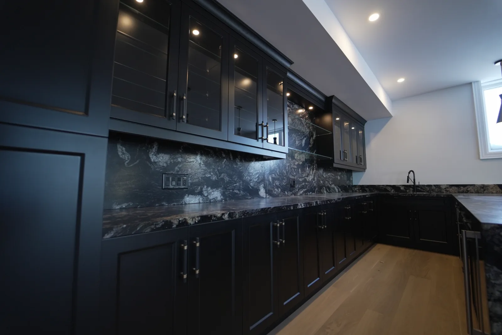 Eco Stone black granite countertop and full-height backsplash installation