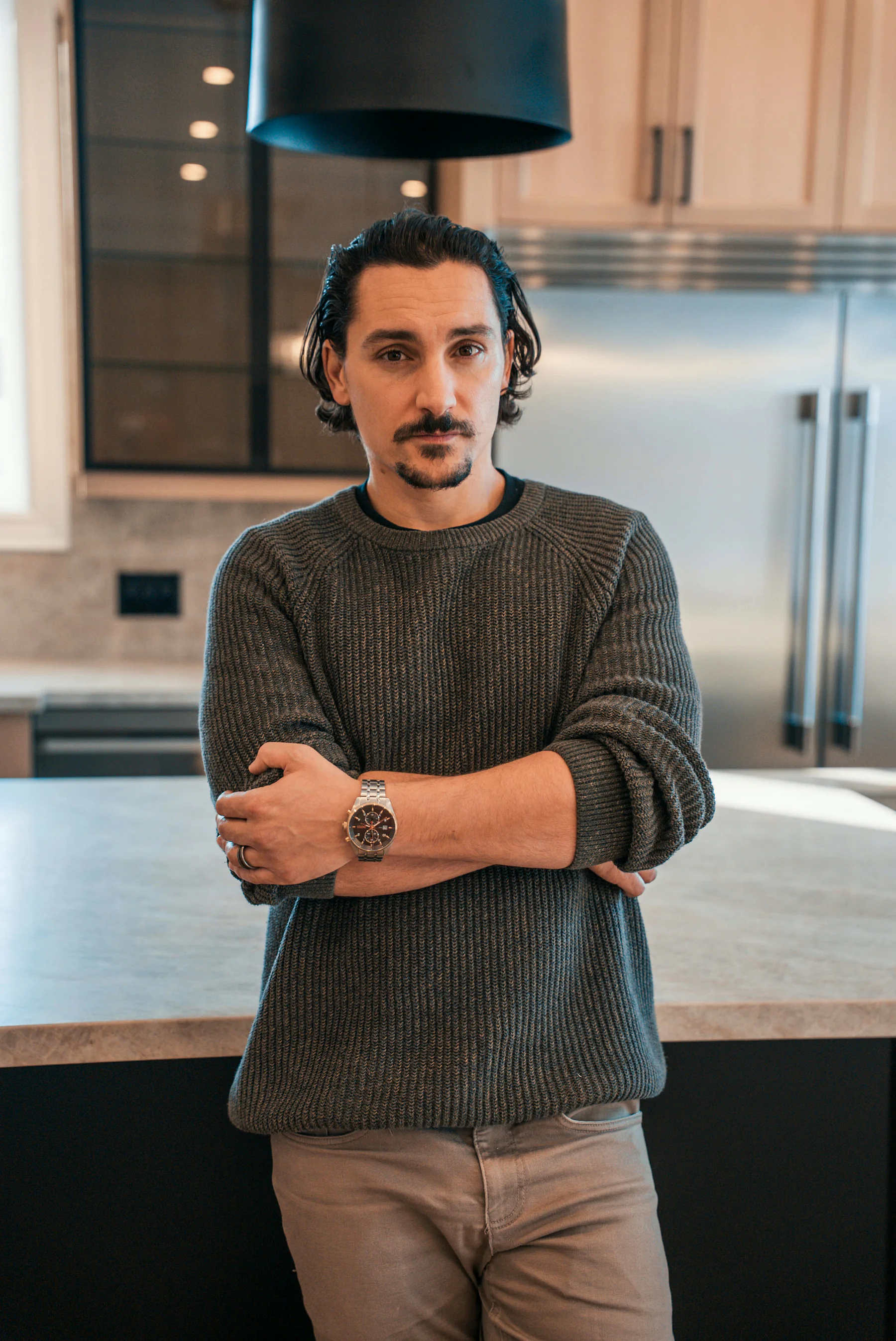 Dom, founder of Eco Stone, in a completed kitchen