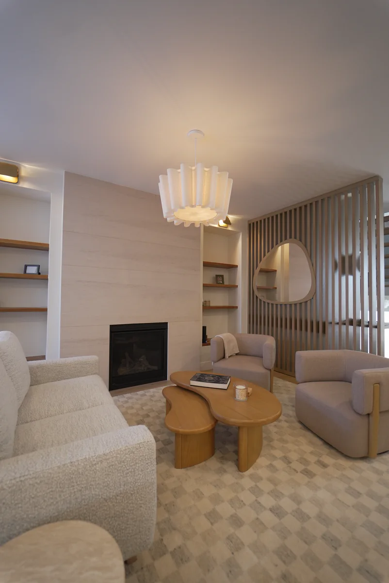 Detailed view of the living room's pale stone fireplace surround