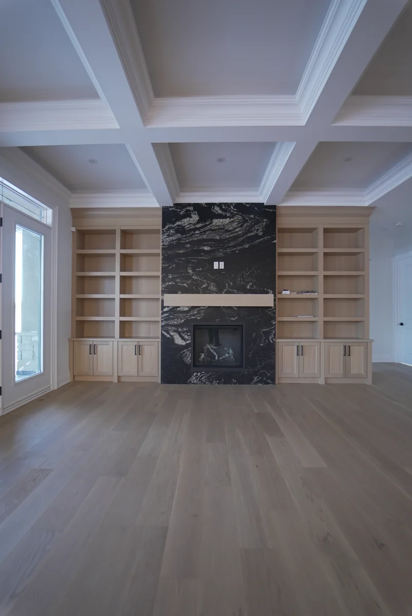 Living room with a floor-to-ceiling richly figured black stone fireplace
